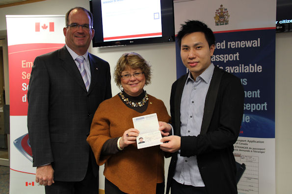 Minister Ablonczy and J. Ian Burchett, Canada’s consul general in Hong Kong, present Law Kok Yu with his renewed Canadian passport