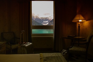 Hotel bedroom with a window overlooking a lake
