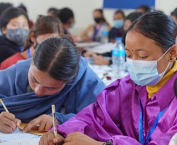 A community health worker in Bangladesh takes a patient’s temperature