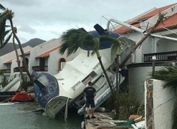 An overturned boat crashed into waterfront apartments during Hurricane Irma (2017).