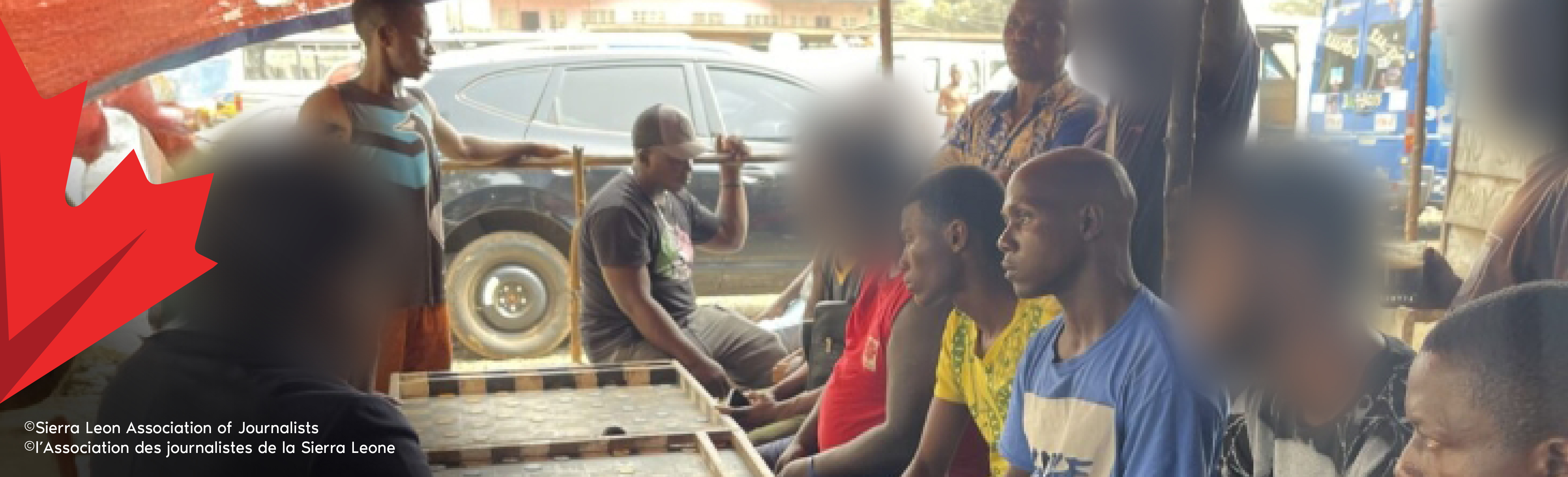 A group of men sitting around a table having a discussion.