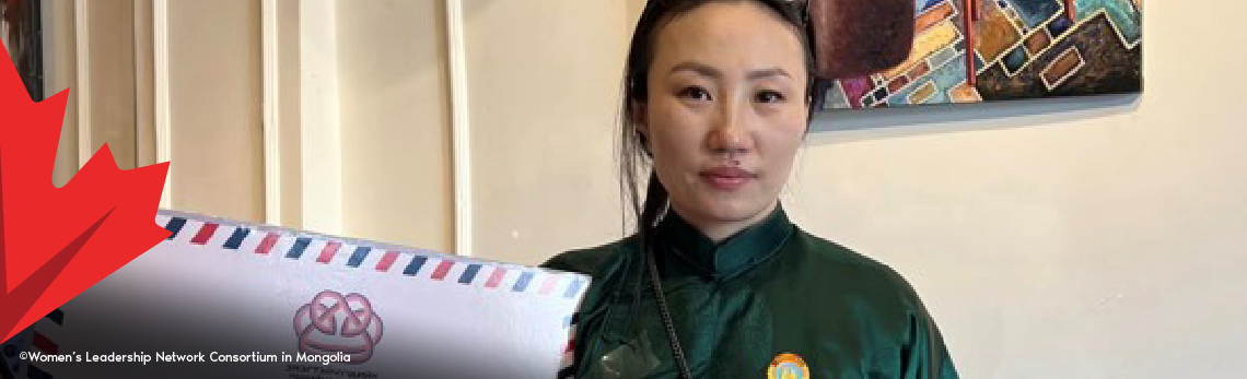 A Mongolian woman wearing a green shirt holds up a sign during a press conference by the Women&rsquo;s Leadership Network in Mongolia.