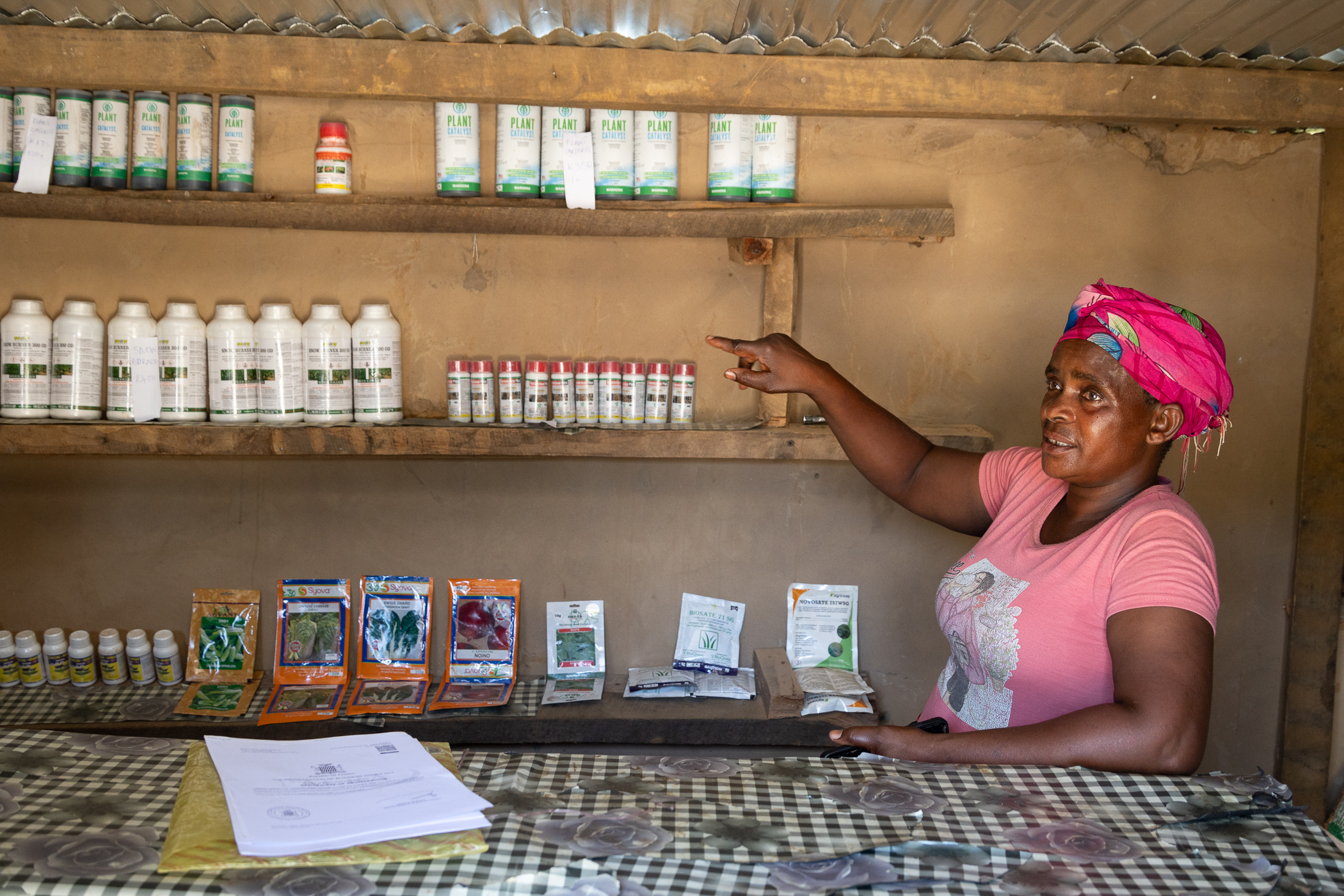 Annie pointing at her shop&rsquo;s products.